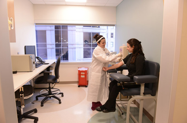 Phlebotomist with patient